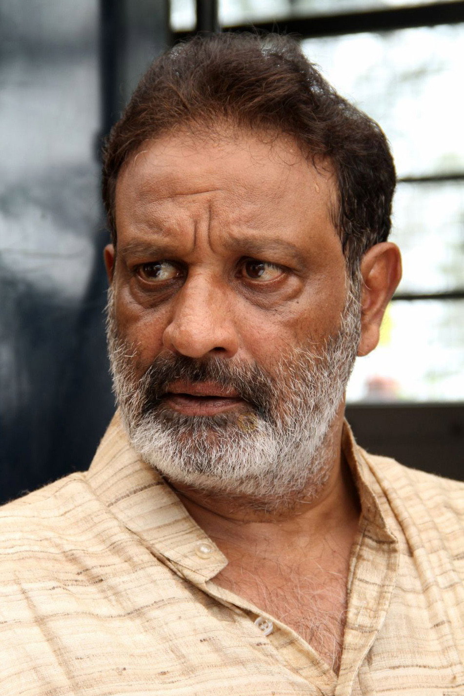 Pithamagan Mahadevan as Loan Shark in Enakkul Oruvan