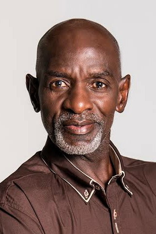 Ernest Ndhlovu as Reverend Bricks in Dark City