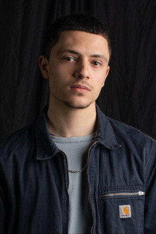 Luca Kamleh-Chapman as Bazi in The Gathering