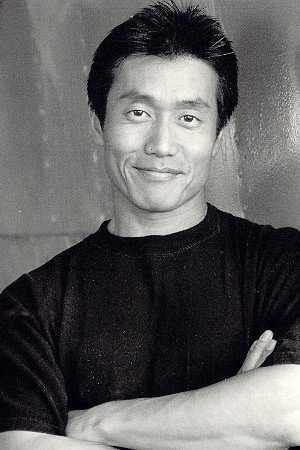 Toshiya Agata as Trainer in Gun Woman