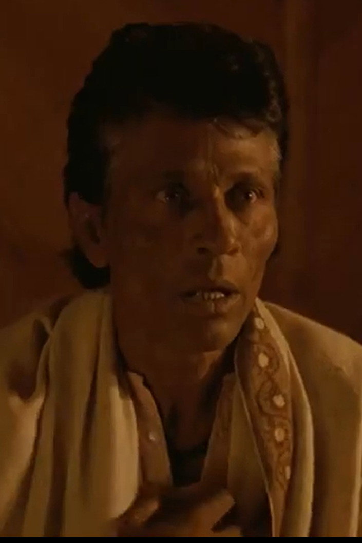 Noni Ganguly as 'Scarface' Jadu in Distant Thunder