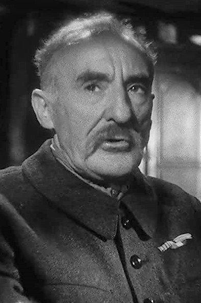 Guy Favières as Patron Commissaire in The Secret of 421