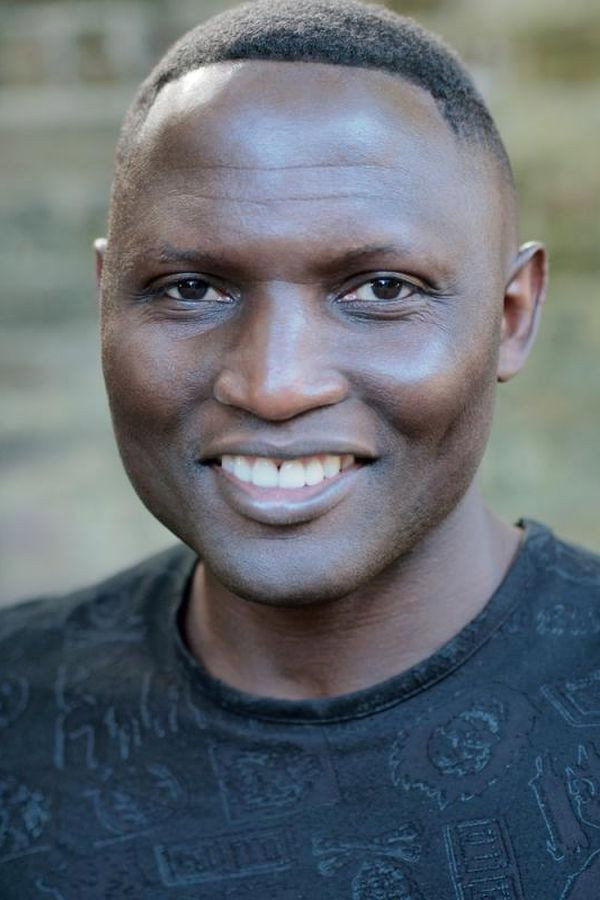 Lamin Tamba as Amos Taiwo / Father Soma in G.O.D.TECH