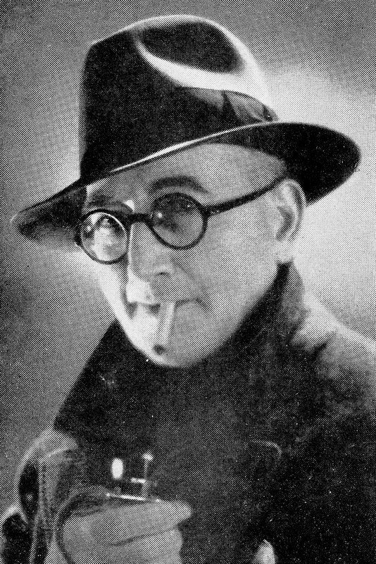Marcel Simon as M. Corollaire, pharmacien et maire de la ville in He