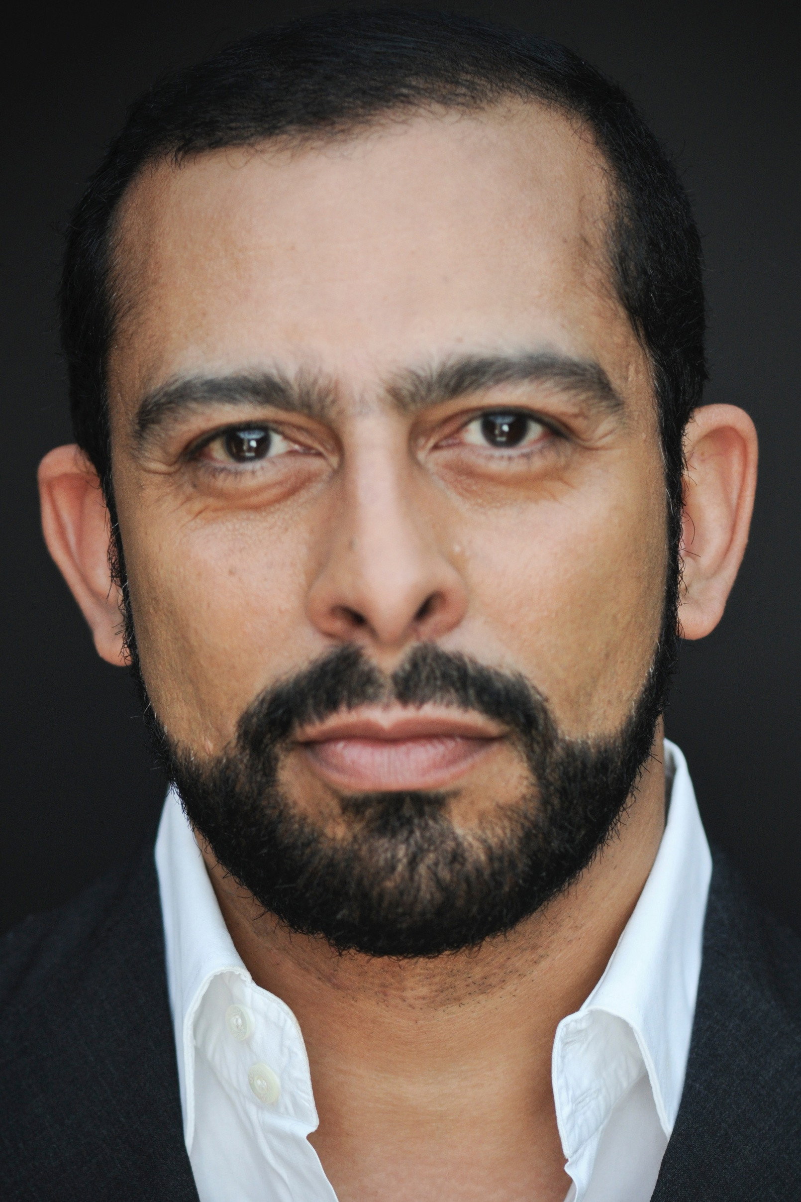 Emilio Doorgasingh as Mr. Patel in Gangsters Gamblers Geezers