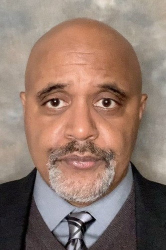 Evander Duck Jr. as District Attorney in Evil Genius