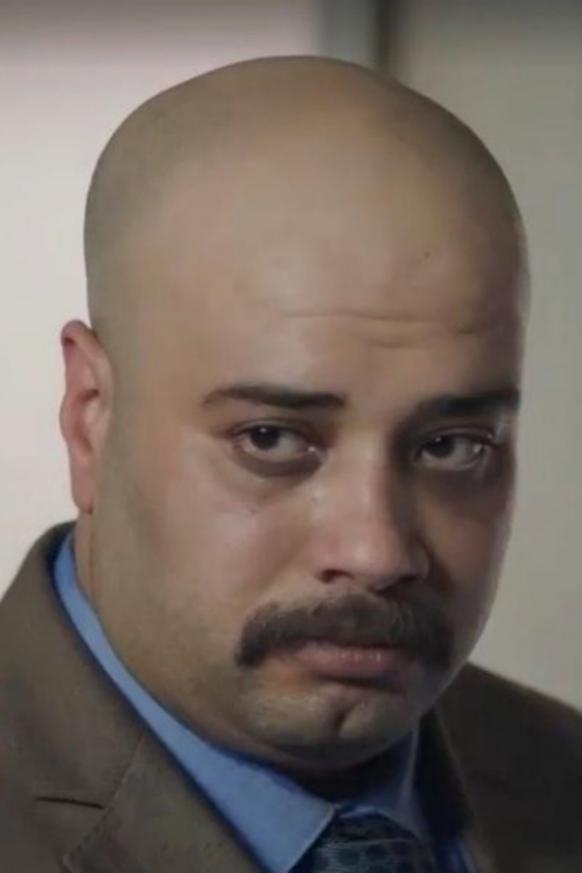 Hatim Salah as Awad in At the door of the building