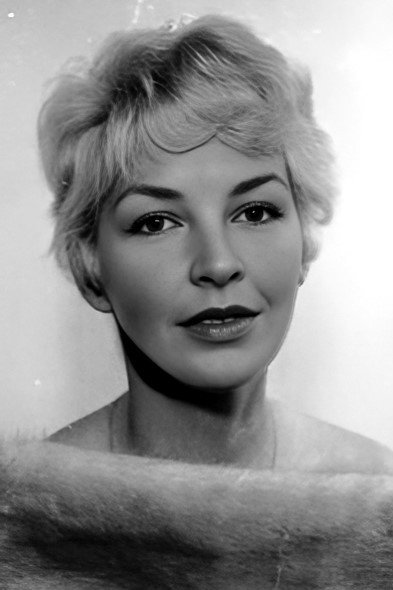 Odile Versois as The wife at the bistro of the former gendarme in Drummer-Crab