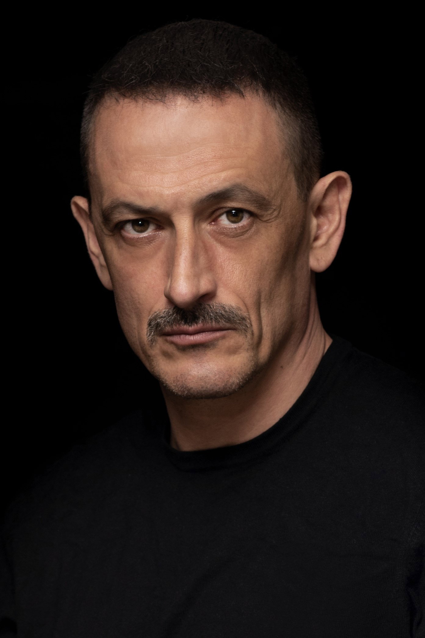 Francisco Boira as Padre Dan in Caged Wings