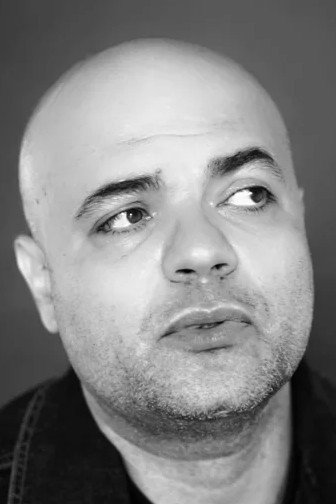 Marcel Cobzariu as The Director in The Counting Device