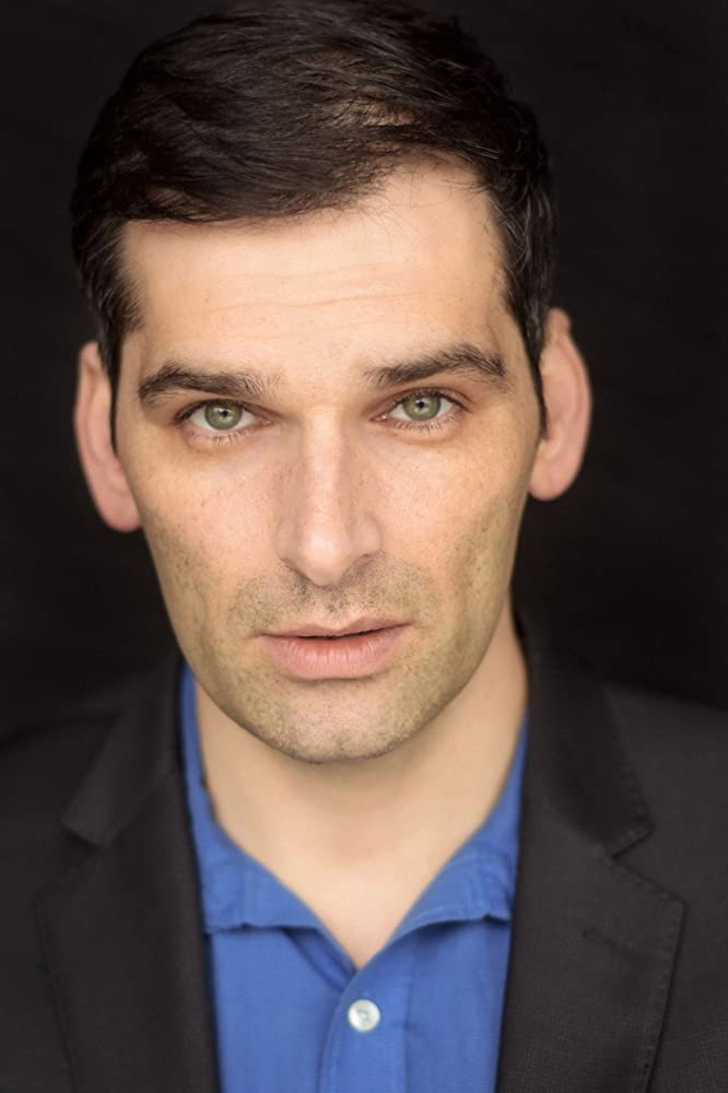 Donal Thoms-Cappello as The Voice (voice) in A.M.