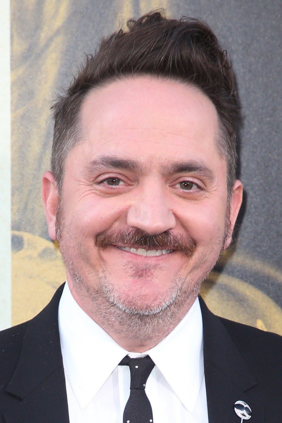 Ben Falcone as Clark Thompson in God's Favorite Idiot