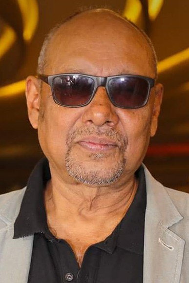 Anjan Dutt as Tirthankar "Tony" Roy in Murder in the Hills