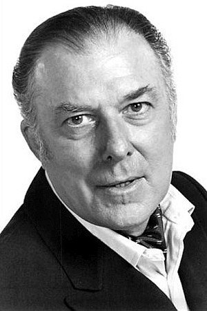 Michael Evans as Chairman in Olivia