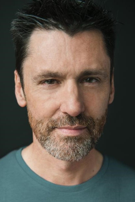Dominic O'Flynn as Doctor Nikos in Wastelands