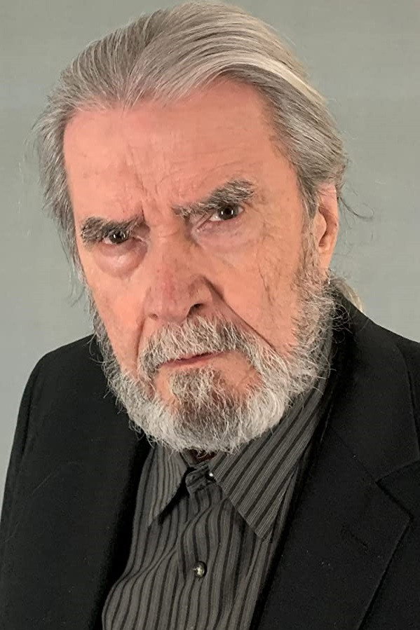 Johnny McPhail as The Traveler in All That You Love Will Be Carried Away