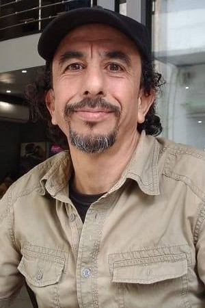 Ahmed Yarziz as The barber in The Unknown Saint