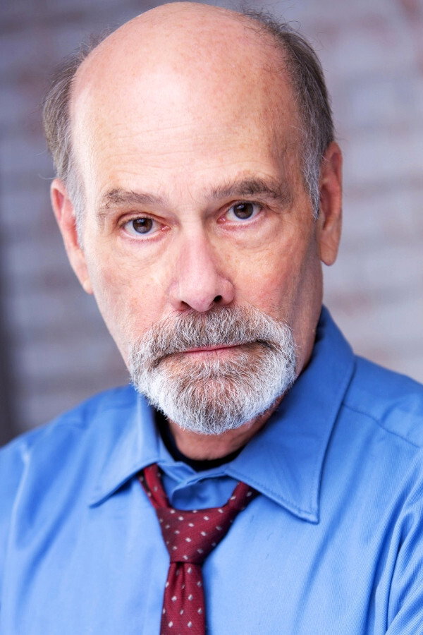 Hugh Holub as Father Macey in Bad Sister