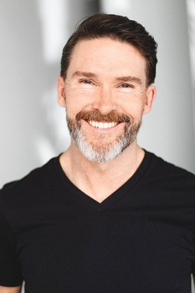 Rick Hughes as Father McCarron in Tales from the Void: Carry
