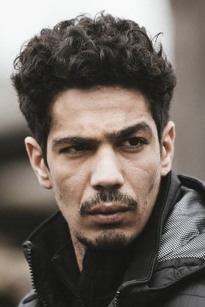 Anis Benbatoul as Kouame in Earth and Blood